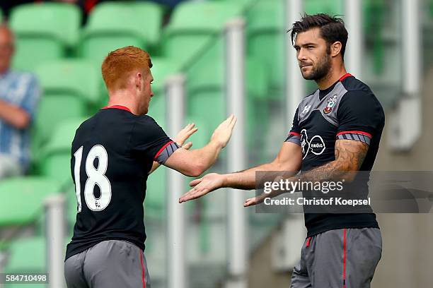 Charlie Austin of Southampton celebrates the first goal with Harrison Reed of Southampton during the friendly match between FC Groningen an FC...