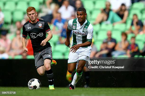 Lt Harrison Reed of Southampton challenges Juninho Bacuna of Groningen during the friendly match between FC Groningen an FC Southampton at Euroborg...