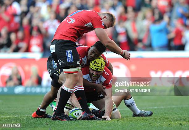 Lions' Lourens Erasmus celebrates with teammates Howard Mnisi and Ruan Ackermann after scoring a try during the SuperXV rugby semi-final match...
