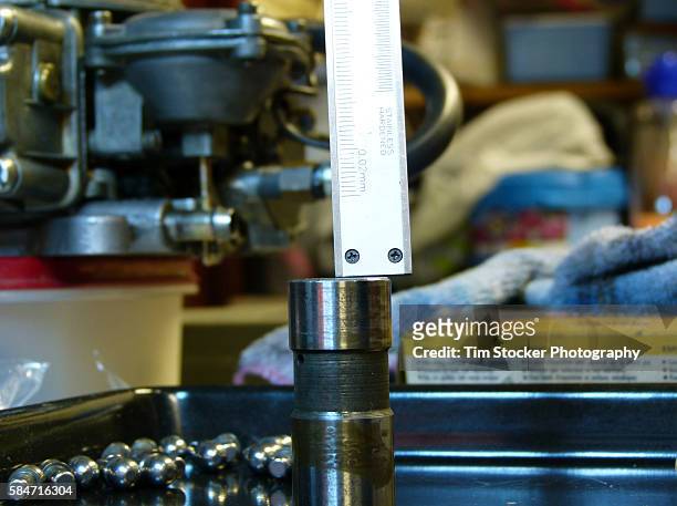 a mechanic using a vernier caliper to check a car engine component for wear - vernier caliper stock-fotos und bilder