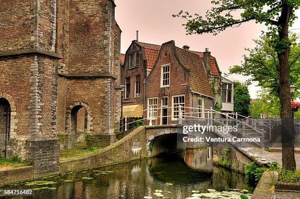 canal, bridge and nieuwe kerk, delft - nieuwe kerk delft stock pictures, royalty-free photos & images