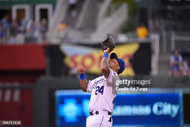 Christian Colon of the Kansas City Royals catches a ball against the Texas Rangers at Kauffman Stadium on July 23, 2016 in Kansas City, Missouri.