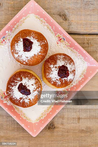 sufganiot, doughnuts. a traditional jewish hanukah dessert - sufganiyah stock-fotos und bilder