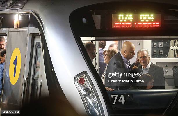 Interim President Michel Temer and Rio de Janeiro Governor Luiz Fernando de Silva ride on the new Metro Line 4 subway train during an event...