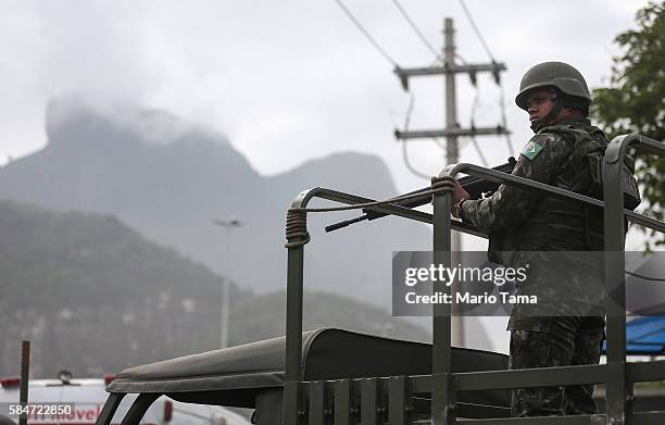 Soldiers keep watch before an event inaugurating a new subway line July 30, 2016 in Rio de Janeiro, Brazil. After many delays, the new station on the...