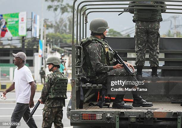 Soldiers keep watch before an event inaugurating a new subway line July 30, 2016 in Rio de Janeiro, Brazil. After many delays, the new station on the...