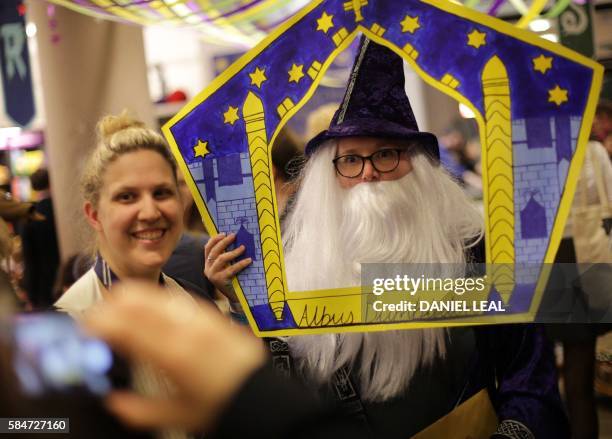 Harry Potter fan dressed as a character from the Harry Potter books poses for a photograph inside Waterstones bookshop on Piccadilly in central...