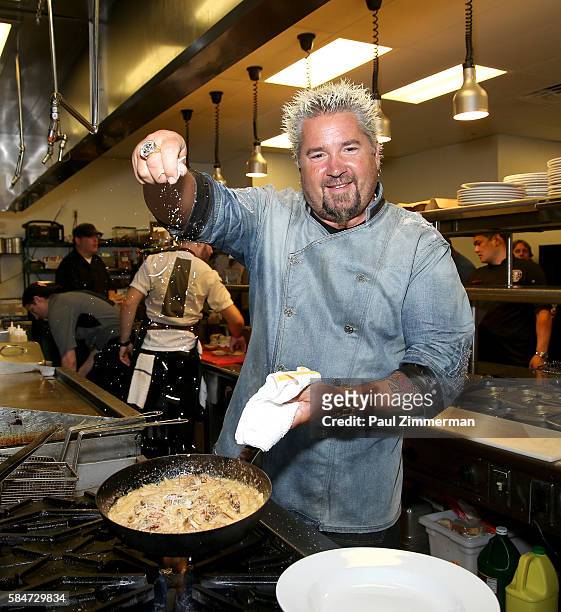 Personality and chef Guy Fieri prepares a meal at his restaurant Guy Fieri's Mt. Pocono Kitchen during the Guy Fieri Meet & Greet held at Mount Airy...