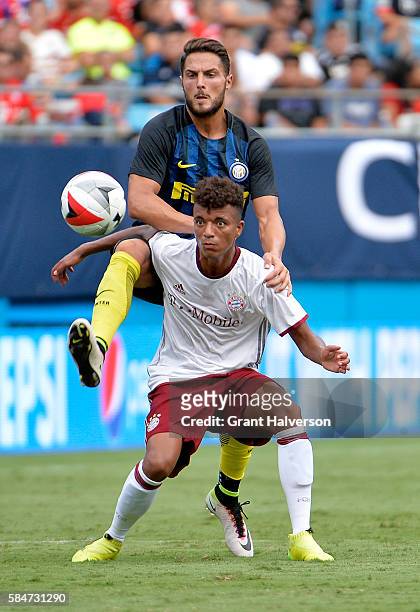 Danilo D'Ambrosio of FC Internazionale challenges Timothy Tillman of FC Bayern Munich for the ball during an International Champions Cup match at...