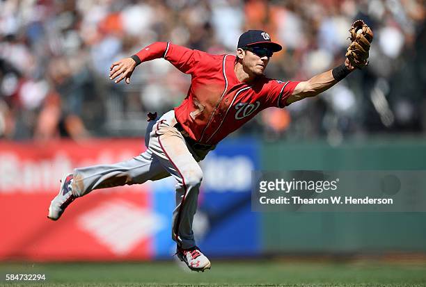 Trea Turner of the Washington Nationals dives to take a hit a way from Conor Gillaspie of the San Francisco Giants in the bottom of the seventh...