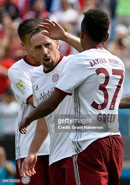 Franck Ribery celebrates with teammate Julian Green of FC Bayern Munich after scoring the opening goal of the match against FC Internazionale during...