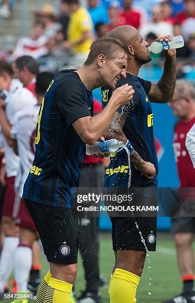 Inter Milan's Caner Erkin cools off during a water break due to the heat during an International Champions Cup match against Bayern Munich in...