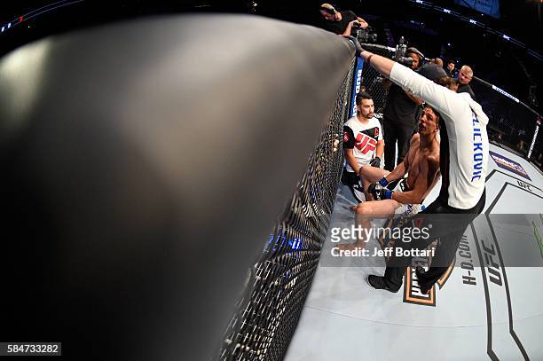 Bojan Velickovic receives advice from his corner in between rounds while facing Michael Graves in their welterweight bout during the UFC 201 event on...