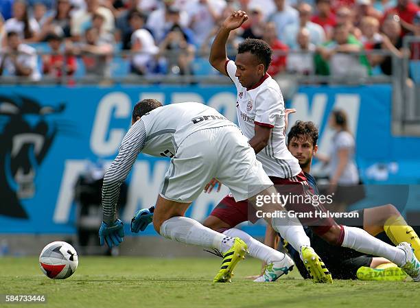 Julian Green of FC Bayern Munich battles Samir Handanovic and Andrea Ranocchia of FC Internazionale for a loose ball in front of the net during an...