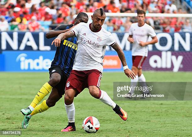 Geoffrey Kondogbia of FC Internazionale chellenges Arturo Vidal of FC Bayern Munich during an International Champions Cup match at Bank of America...