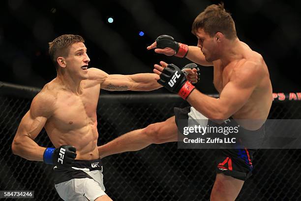 Michael Graves and Bojan Velickovic of Serbia trade strikes in their welterweight bout during the UFC 201 event on July 30, 2016 at Philips Arena in...