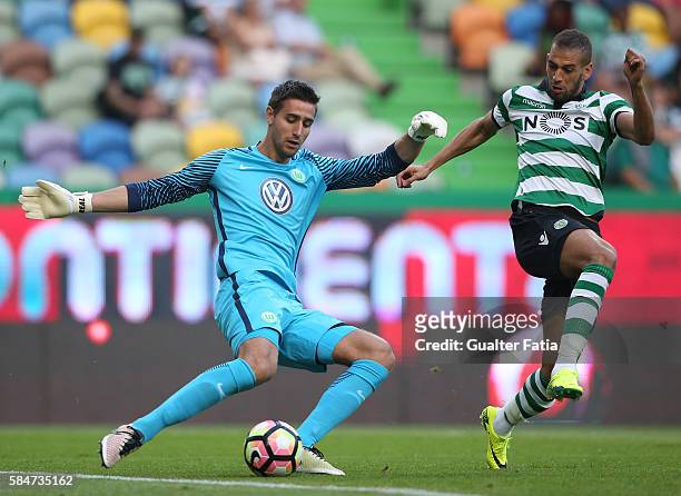 Wolfsburg's goalkeeper Koen Casteels with Islam Slimani in action during the Pre Season Friendly match between Sporting CP and Wolfsburg at Estadio...