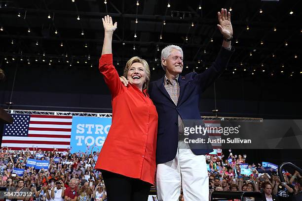 Democratic presidential nominee former Secretary of State Hillary Clinton and her husband former U.S. President Bill Clinton greet supporters during...