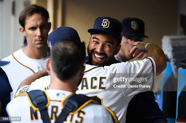 Matt Kemp of the San Diego Padres gets a hug from Brett Wallace before a baseball game against the Cincinnati Reds at PETCO Park on July 30, 2016 in...