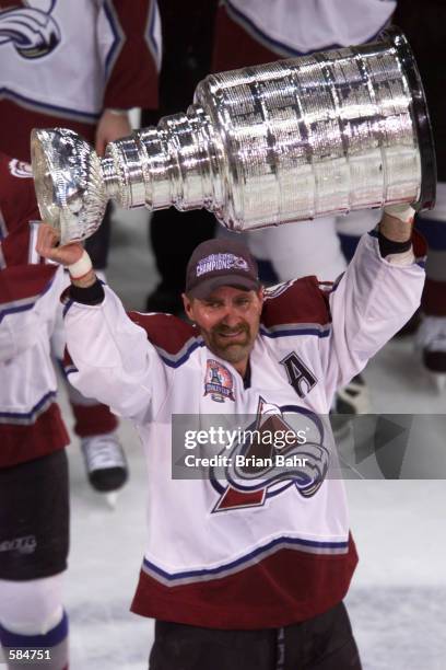 Ray Bourque of the Colorado Avalanche hoists the Stanley Cup after defeating the New Jersey Devils during the Stanley Cup finals at the Pepsi Center...