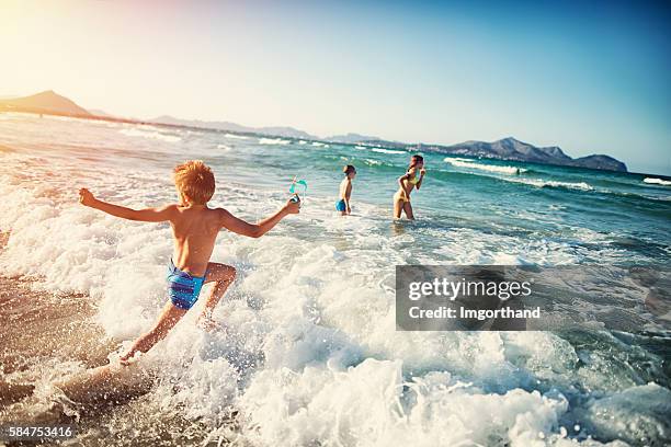 summer vacations - kids playing at sea - child swimming stock pictures, royalty-free photos & images