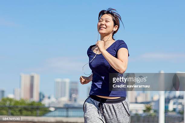 young japanese girl running in the morning at tokyo - relaxation exercise stock pictures, royalty-free photos & images