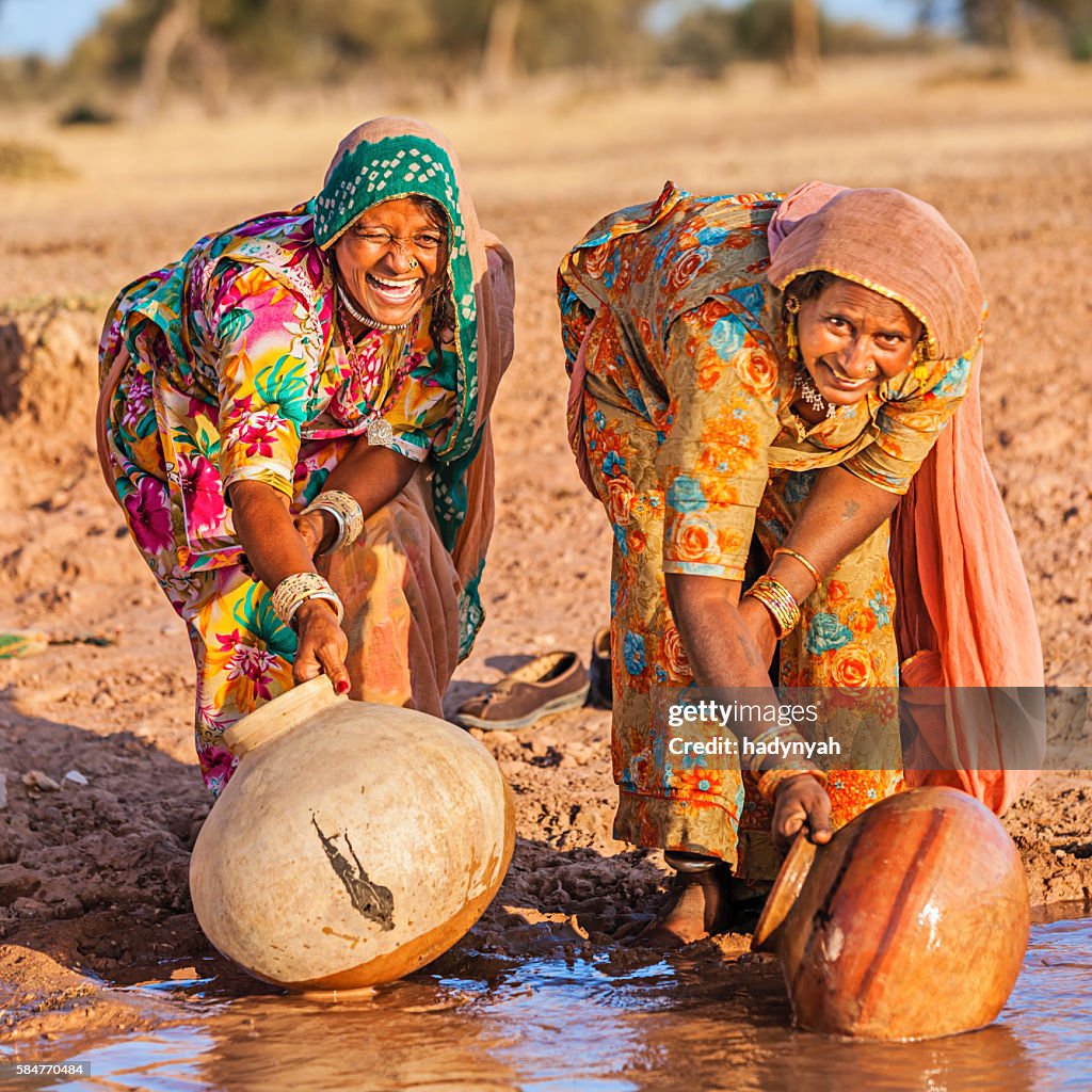 Indian women collecting water from the lake, Rajasthan