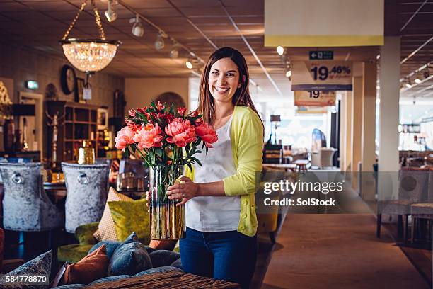 enjoying her job! - sales assistant furniture stock pictures, royalty-free photos & images