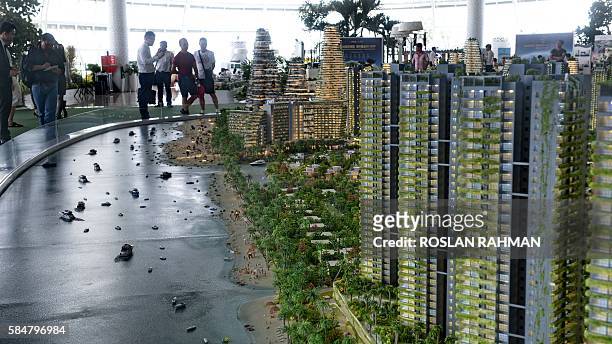 This picture taken on April 19, 2016 shows the scale model of development at Forest-City on one of the man-made islands on the Malaysian side of the...