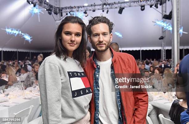 Model Jenny Albright and blogger Isaac Hindin-Miller attend the 23rd Annual Watermill Center Summer Benefit & Auction at The Watermill Center on July...