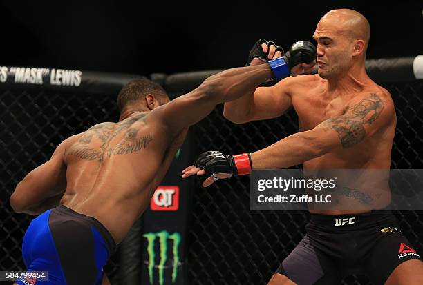 Tyron Woodley delivers a right hand to knock down opponent Robbie Lawler in their welterweight championship bout during the UFC 201 event on July 30,...