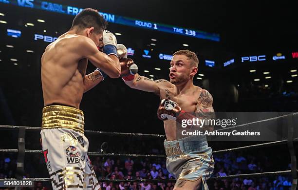 Leo Santa Cruz of Mexico fights Carl Frampton of Northern Ireland during their 12 round WBA Super featherweight championship bout at Barclays Center...