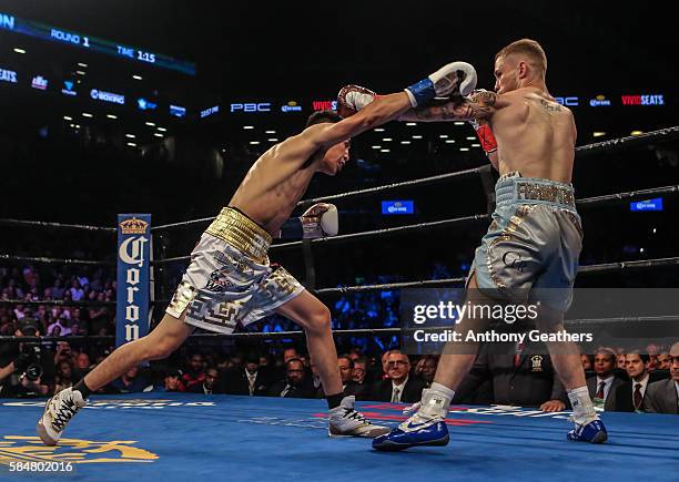 Leo Santa Cruz of Mexico fights Carl Frampton of Northern Ireland during their 12 round WBA Super featherweight championship bout at Barclays Center...