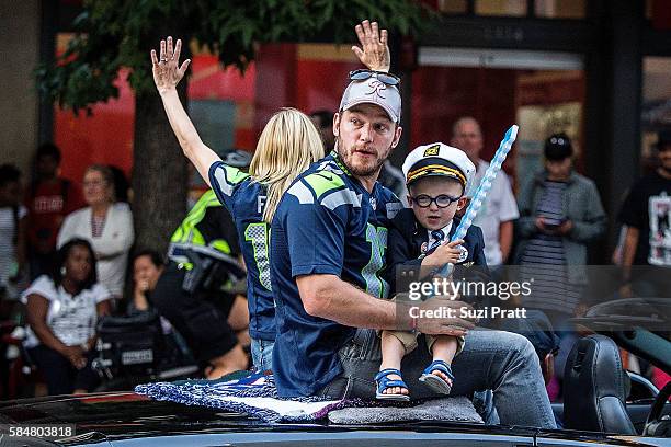 Actor Chris Pratt and son Jack Pratt ride in the Seafair Torchlight Parade Grand Marshal vehicle on July 30, 2016 in Seattle, Washington.