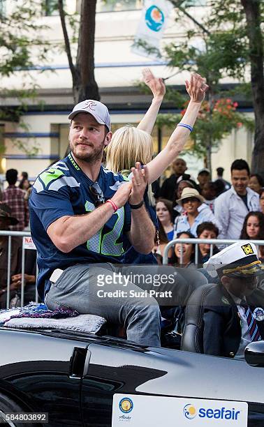 Actor Chris Pratt and son Jack Pratt ride in the Seafair Torchlight Parade Grand Marshal vehicle on July 30, 2016 in Seattle, Washington.