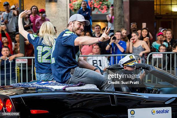 Actor Chris Pratt and son Jack Pratt ride in the Seafair Torchlight Parade Grand Marshal vehicle on July 30, 2016 in Seattle, Washington.