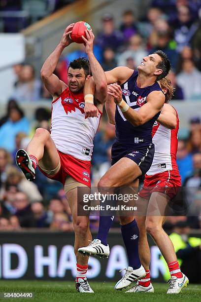 Heath Grundy of the Swans marks the ball against Matthew Pavlich of the Dockers during the round 19 AFL match between the Fremantle Dockers and the...