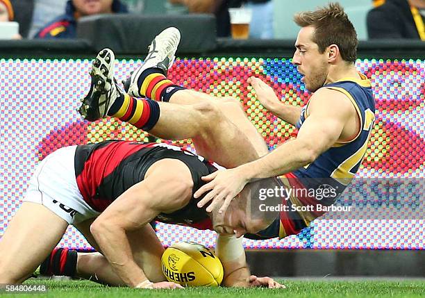 Richard Douglas of the Crows and David Zaharakis of the Bombers compete for the ball during the round 19 AFL match between the Adelaide Crows and the...