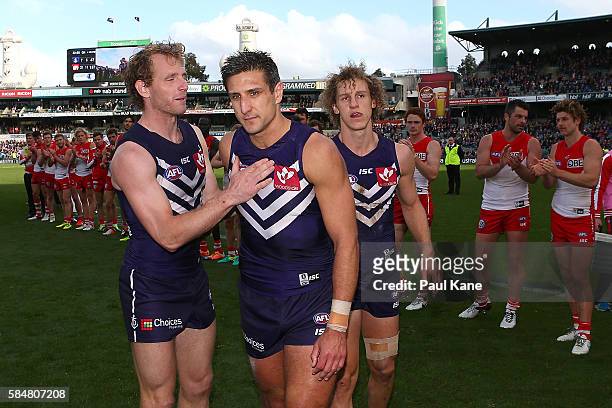 Matthew Pavlich of the Dockers leads the team from the field after playing his 350th game during the round 19 AFL match between the Fremantle Dockers...