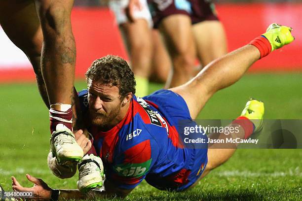 Korbin Sims of the Knights tackles during the round 21 NRL match between the Manly Sea Eagles and the Newcastle Knights at Brookvale Oval on July 31,...