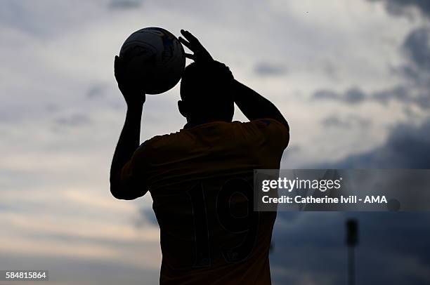 Silhouette of a player preparing for throw in during the Pre-Season Friendly match between AFC Wimbledon and Crystal Palace at The Cherry Red Records...