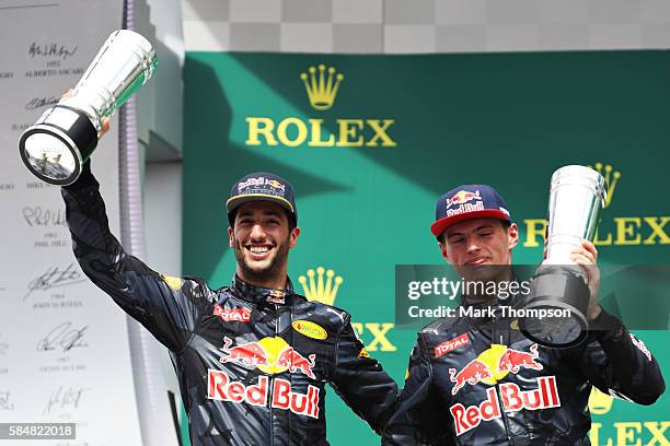 Daniel Ricciardo of Australia and Red Bull Racing and Max Verstappen of Netherlands and Red Bull Racing with their trophies on the podium during the...