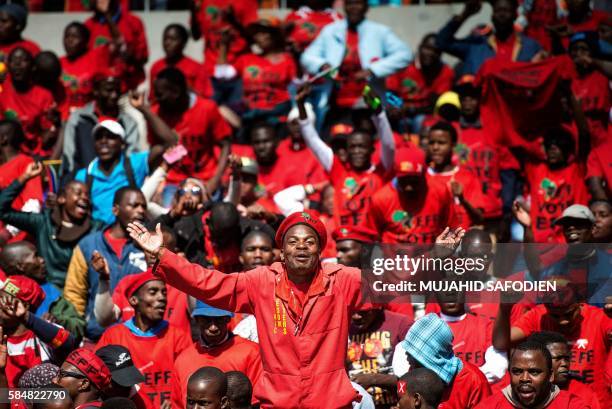 South African radical leftist Economic Freedom Fighters party supporters cheer and dance during the party closing rally campaign ahead of the...