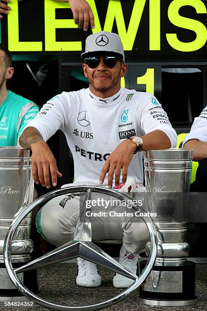 Lewis Hamilton of Great Britain and Mercedes GP celebrates with his team outside the garage after winning the Formula One Grand Prix of Germany at...