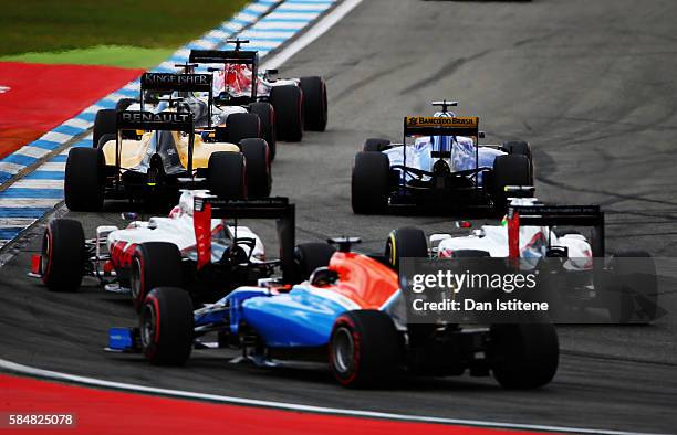 Daniil Kvyat of Russia drives the 3 Scuderia Toro Rosso STR11 Ferrari 060/5 turbo ahead of Sergio Perez of Mexico and Force India, Jolyon Palmer of...