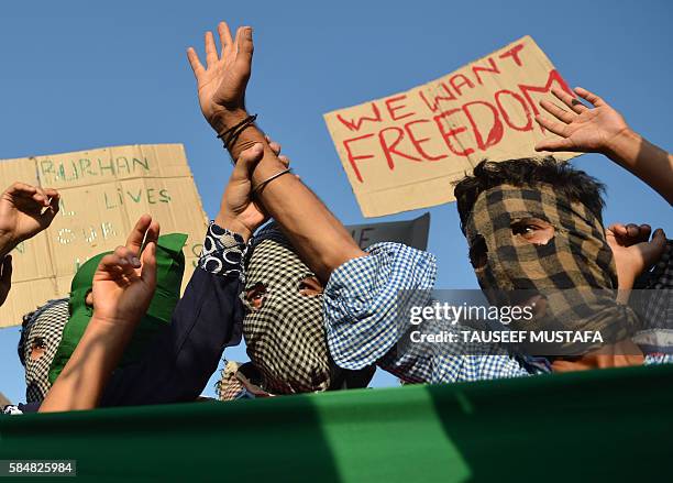 Masked Kashmiri protestors shout pro-Pakistan and pro-freedom slogans during a protest in downtown Srinagar on July 31, 2016 More than 50 people have...