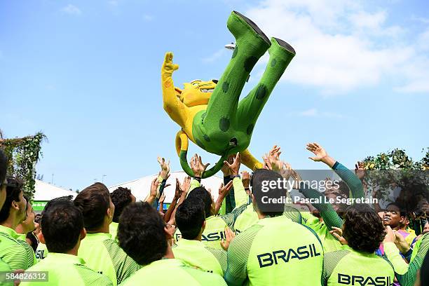 Brazilian team for the 2016 Rio Olympics throw the Rio 2016 mascot in the air in the Athletes Village following their official welcome and flag...