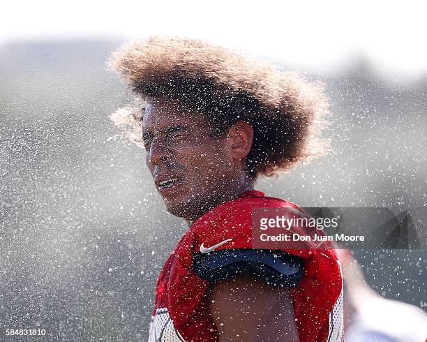 Wide Receiver Kenny Bell of the Tampa Bay Buccaneers shakes out the extra water in his hair while trying to cool down during Training Camp at One Buc...