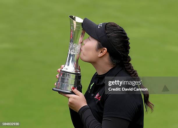 Ariya Jutanugarn of Thailand holds the trophy after her three shot victory during the final round of the 2016 Ricoh Women's British Open on the...