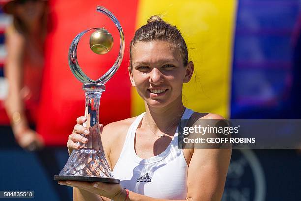 Simona Halep of Romania hoists the Rogers Cup after defeating Madison Keys of the United States in the final at Uniprix Stadium in Montreal, Quebec,...